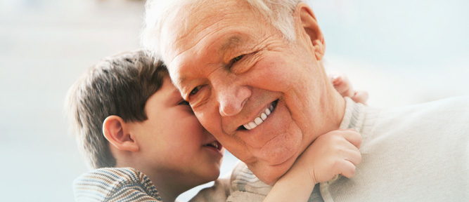 HearingtheGrandchild boy whispering in older man's ear