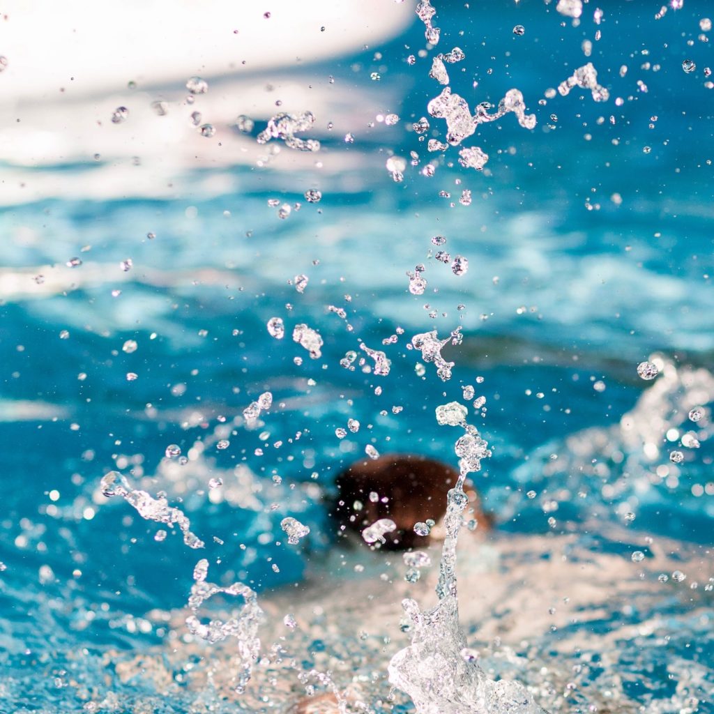 Man submerged in pool after diving in