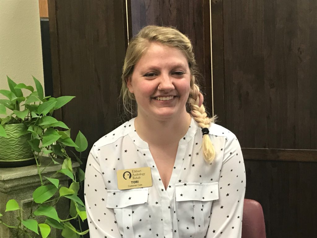 Tori Epperson wearing her Elkhart Audiology Rehab customer care name tag
